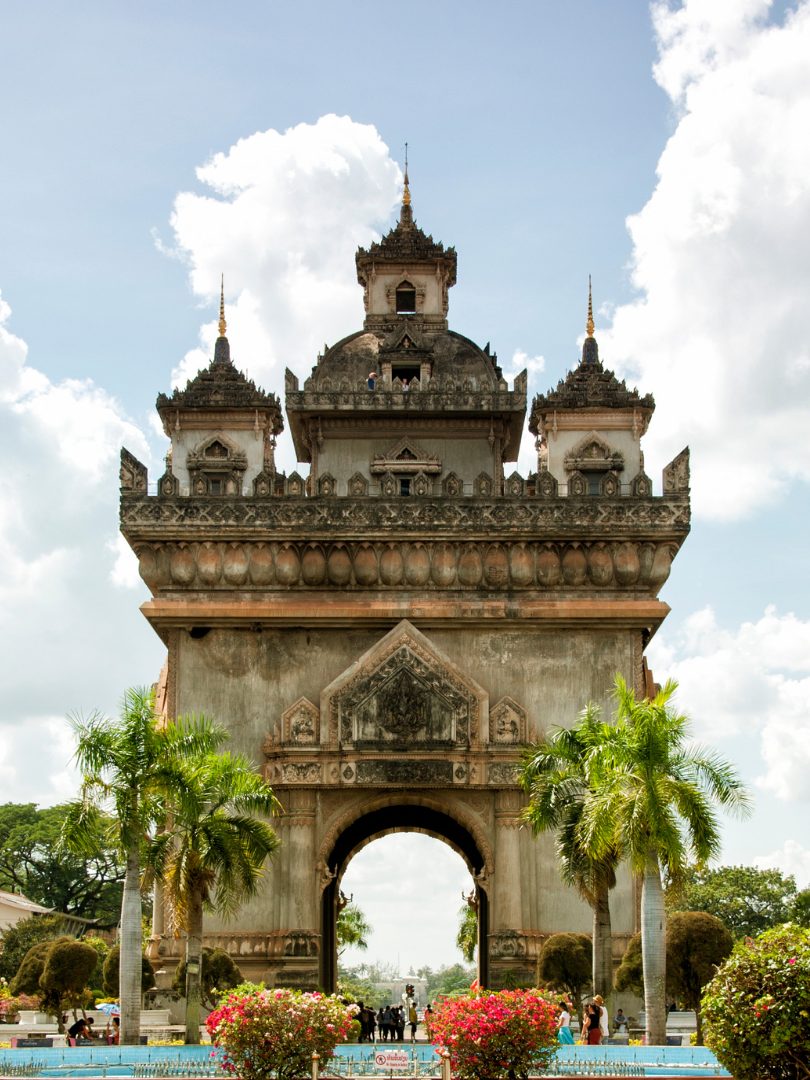 Patuxai victory monument among palms and flowering gardens, Vientiane, Laos